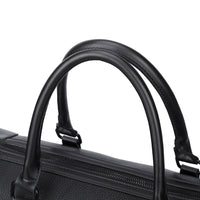 Close-up of a black suitcase handle on a white background