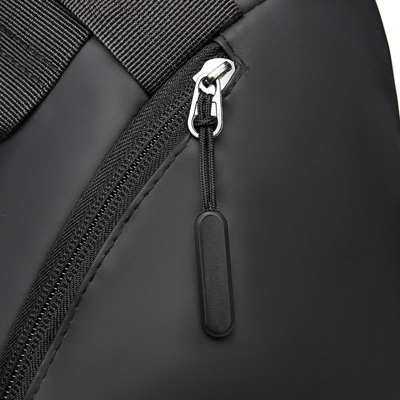 Close-up of a black backpack zipper with a silver pull tab on a white background