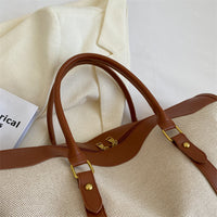 Beige bag with brown handles and straps
