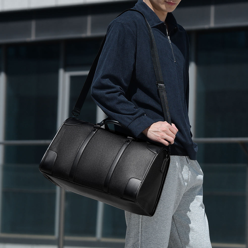 Person carrying Getaway Weekender Duffle Bag during a weekend trip