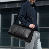 Person carrying Getaway Weekender Duffle Bag during a weekend trip