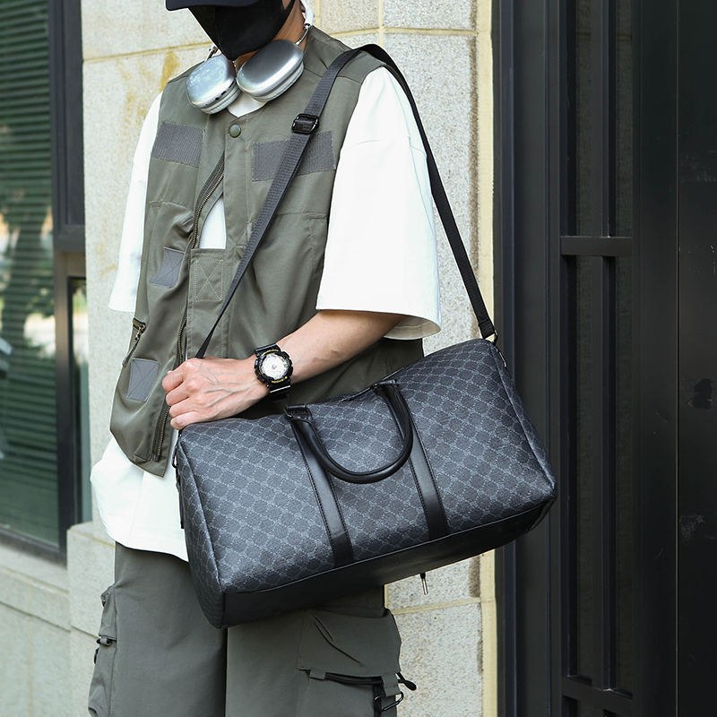Person carrying UrbanLux Premium PU Leather Travel Duffle Bag