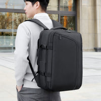 Person wearing a black backpack outdoors